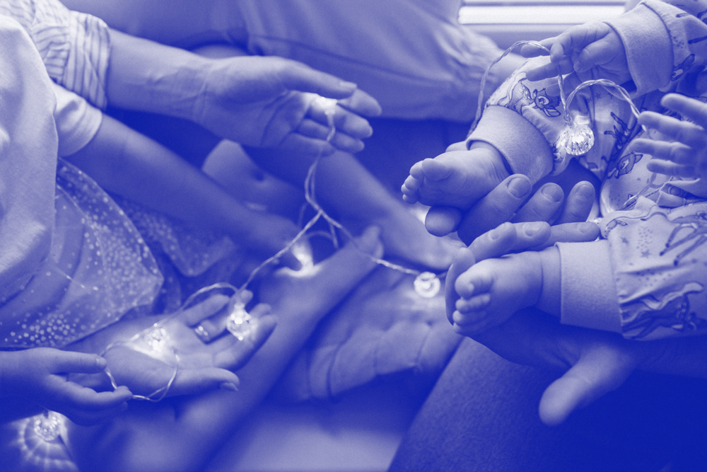 Verbunden sitzende Familie, die zeigt, wie sich Gefühle und Gesundheit in einem Familiensystem mitbewegen.